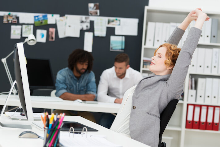 woman stretching at desk