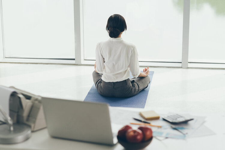 woman doing yoga at office